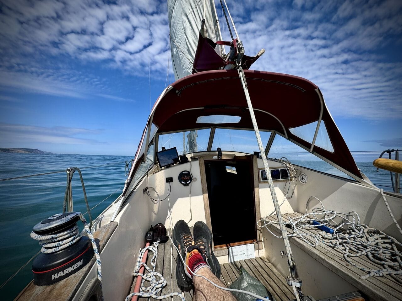 Godiva's cockpit under sail on a calm, sunny day